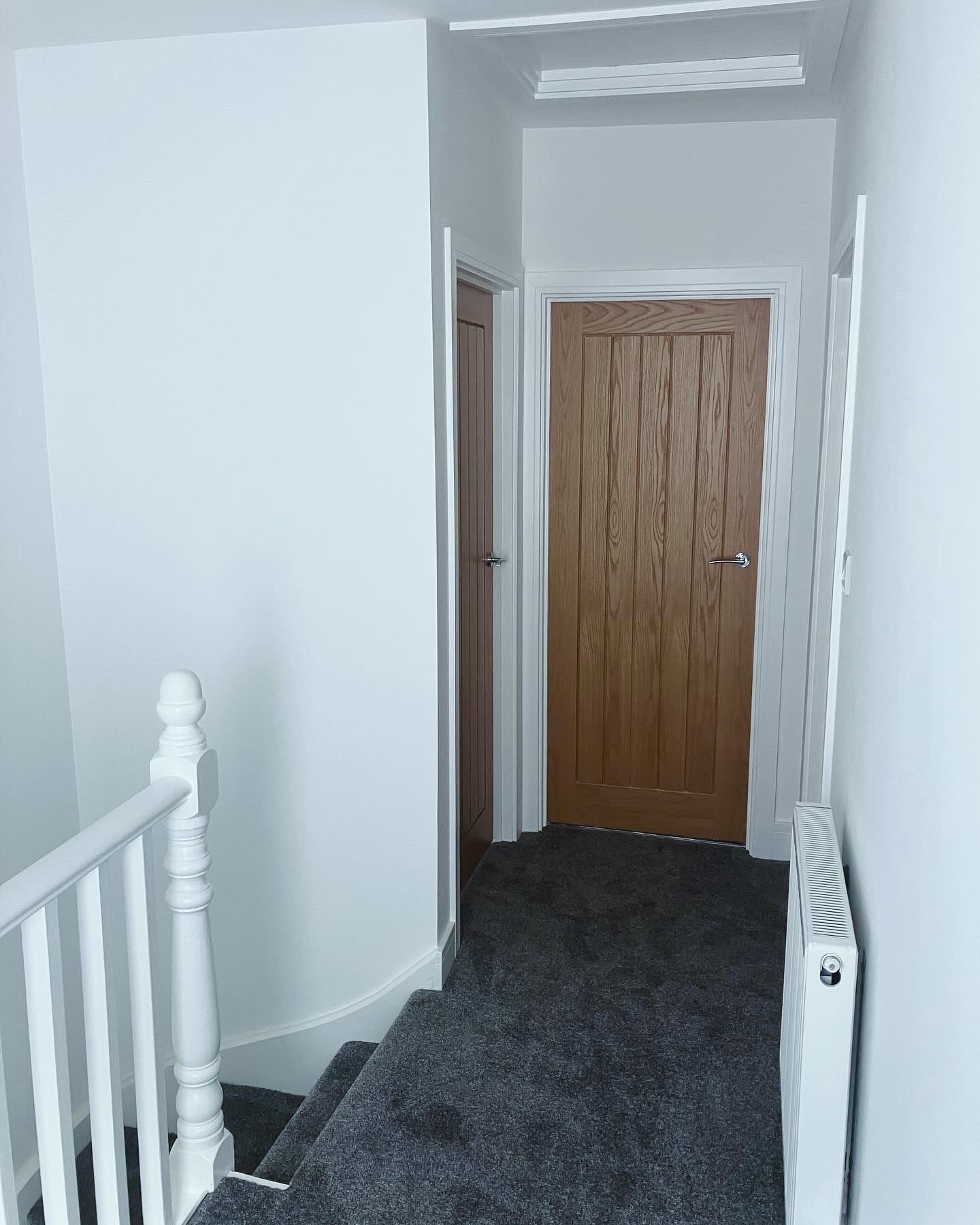 Renovated upstairs hallway with new oak doors, skirting and carpet