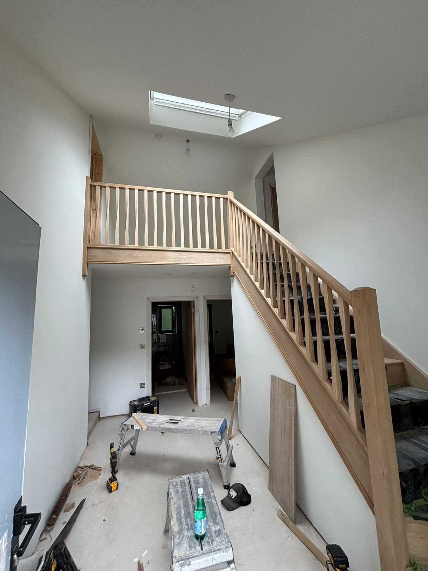 First fix carpentry on site: a new timber staircase and landing balustrade installed under a skylight