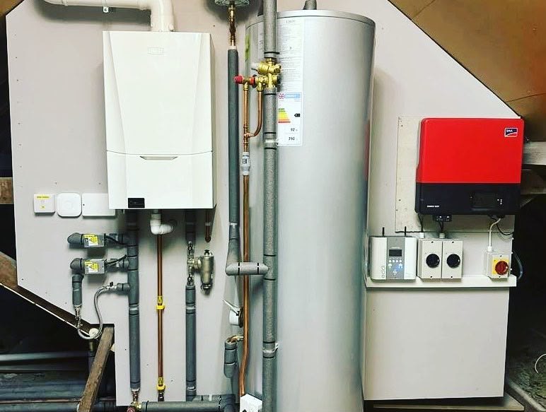 Plant room with a boiler, unvented cylinder and controls installed during a building project