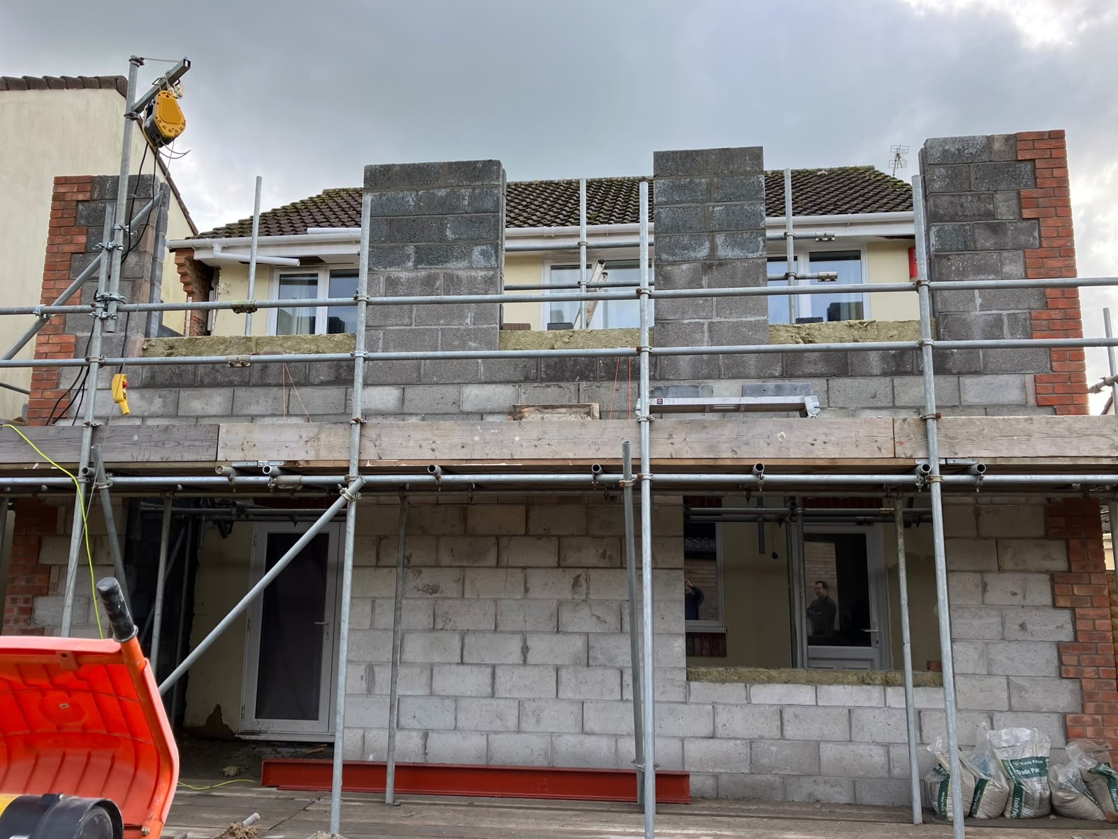 Two-storey extension in progress with scaffolding and new blockwork walls